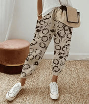 Women's slim-fit trousers with a drawstring, in solid colours and prints