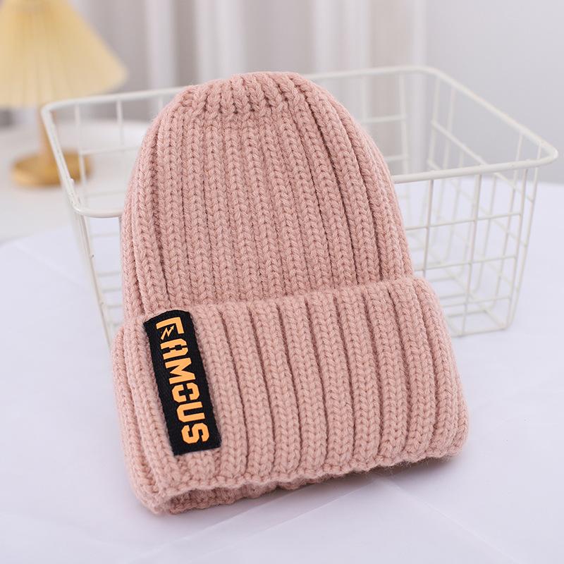 A women's knitted hat with lettering