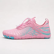 A pink women's barefoot walking shoe with a striped texture and blue sole