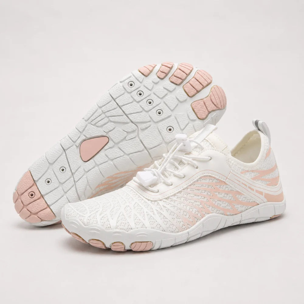 A women's barefoot walking shoe with a white upper and pink/beige treaded sole