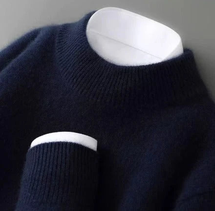 A dark blue knitted round-neck jumper with long sleeves, a ribbed hem and cuffs.