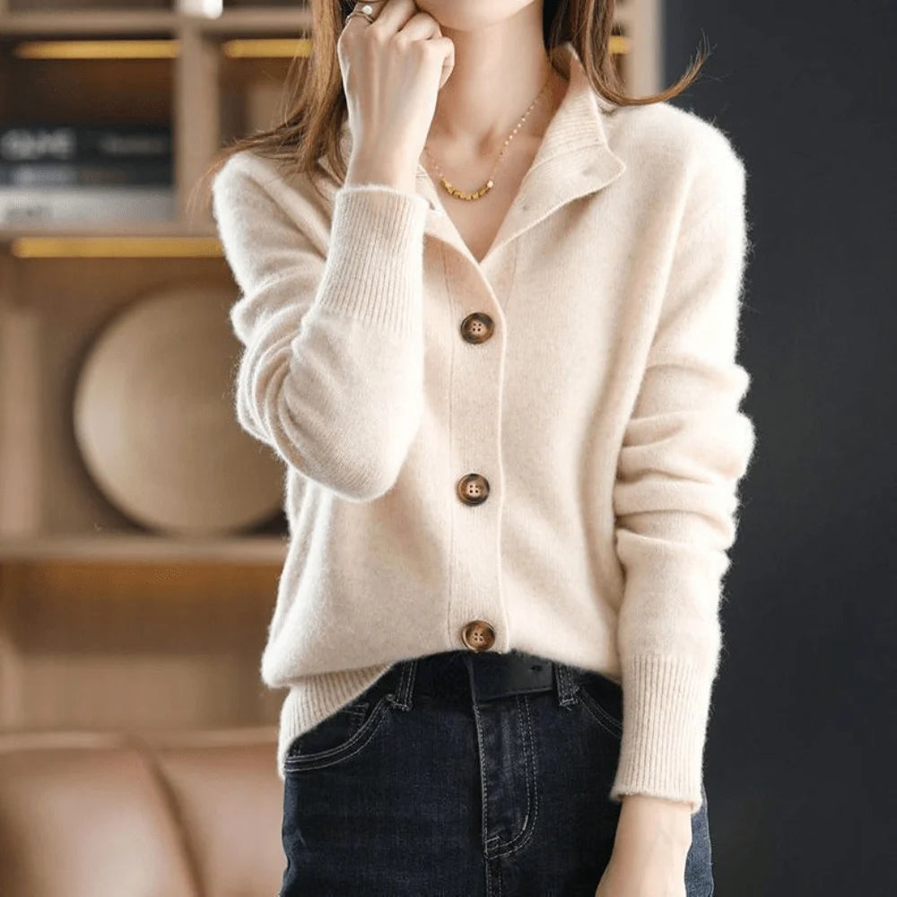 A light beige knitted cardigan with a collar and front button fastening