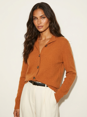 A orange women's knitted cardigan with a collar and buttons