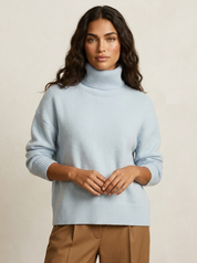 A plain light blue women's knitted roll-neck jumper with long sleeves