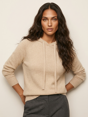 A beige women's knitted hoodie with a drawstring hood and ribbed trims