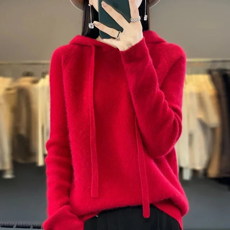 A bright-red women's knitted hoodie with a drawstring hood.