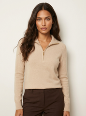 A beige women's knitted jumper with half-zip fastening, a stand collar and long sleeves