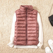 A rose-coloured padded women's gilet with a high collar and zip