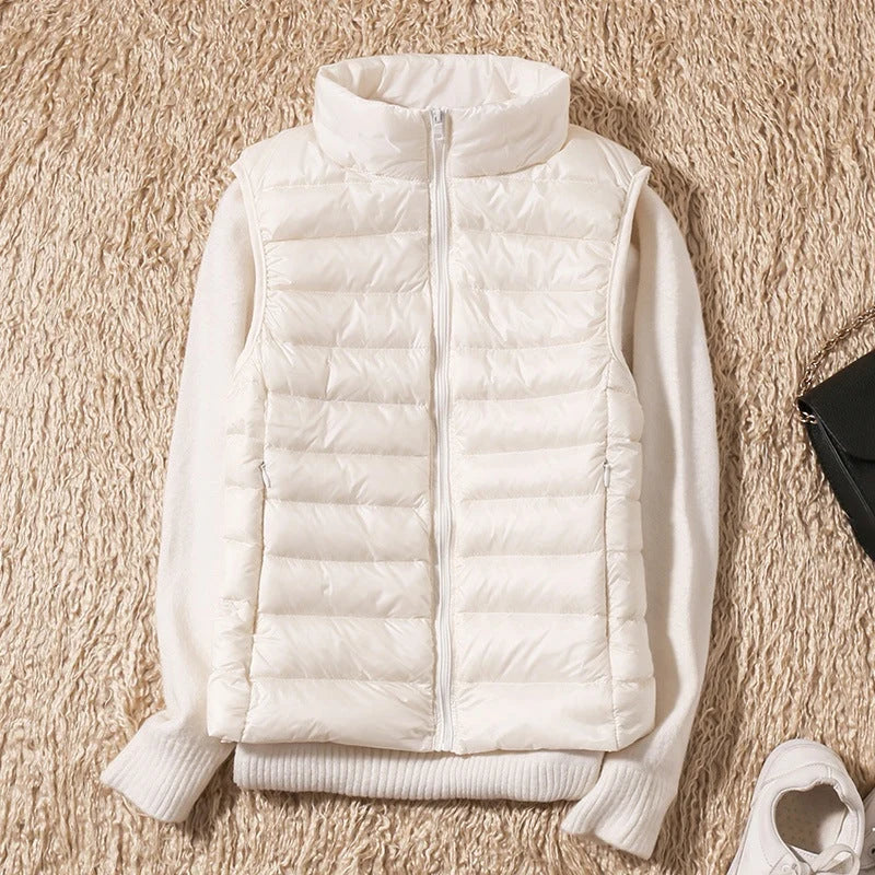 A white padded women's gilet with a high collar and front zip.