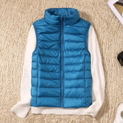 A blue padded women's gilet with a high collar and front zip.