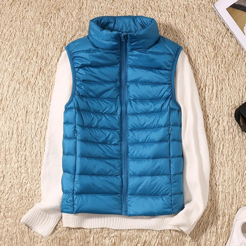 A blue padded women's gilet with a high collar and front zip.