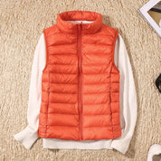 A orange padded women's gilet with a high collar and front zip.