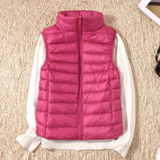 A pink padded women's gilet with a high collar and front zip.