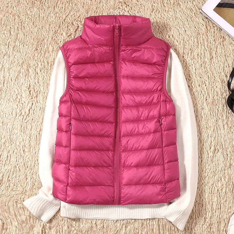 A pink padded women's gilet with a high collar and front zip.
