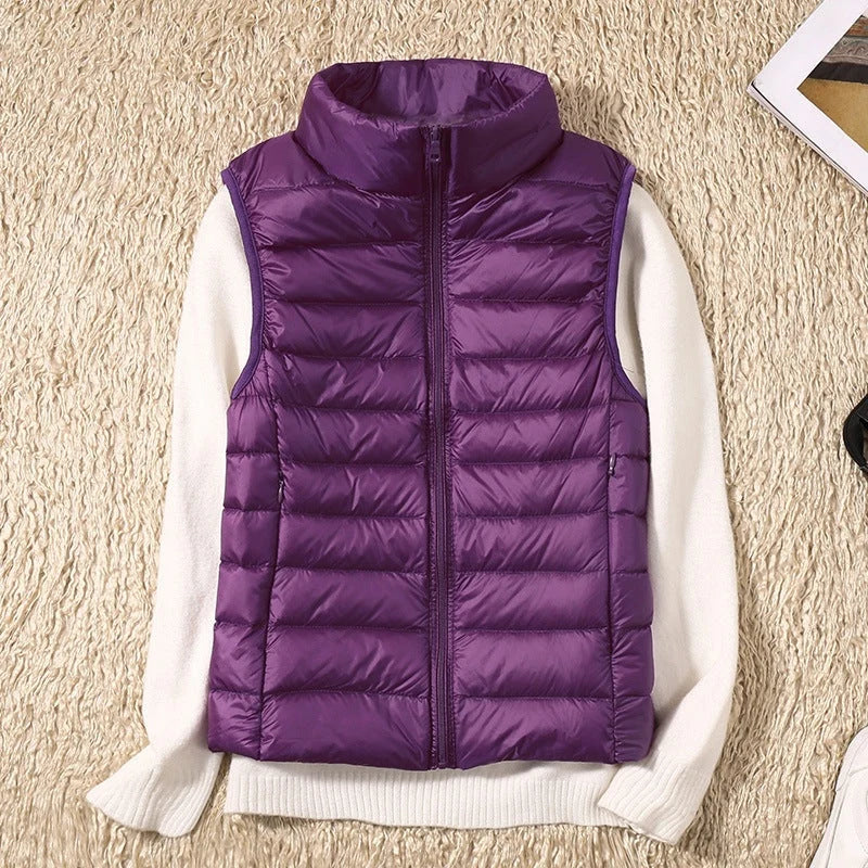 A purple padded women's gilet with a high collar and front zip.