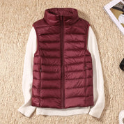 A burgundy padded women's gilet with a high collar and zip.