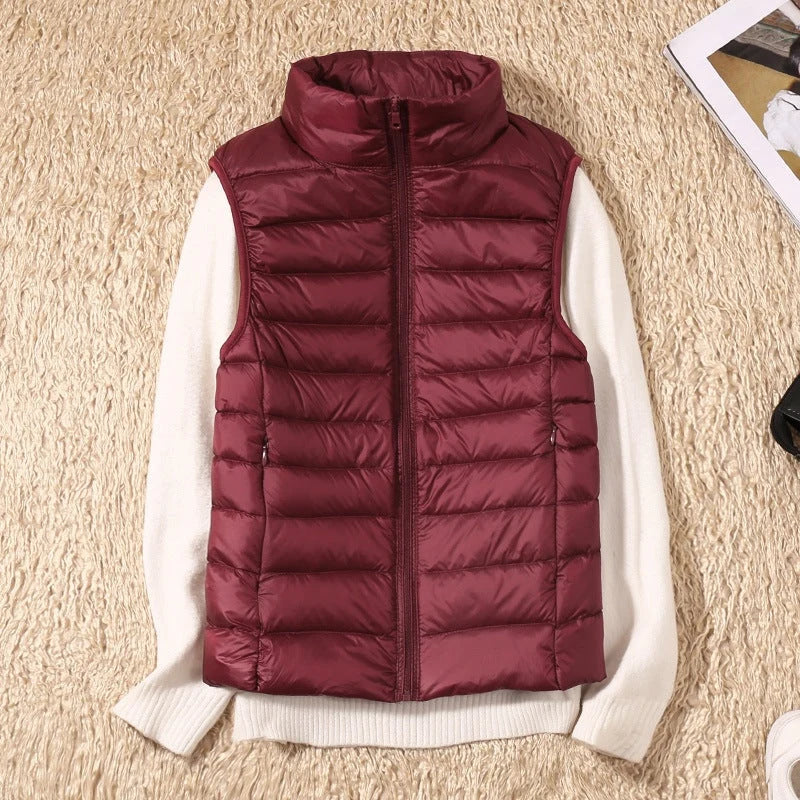 A burgundy padded women's gilet with a high collar and zip.