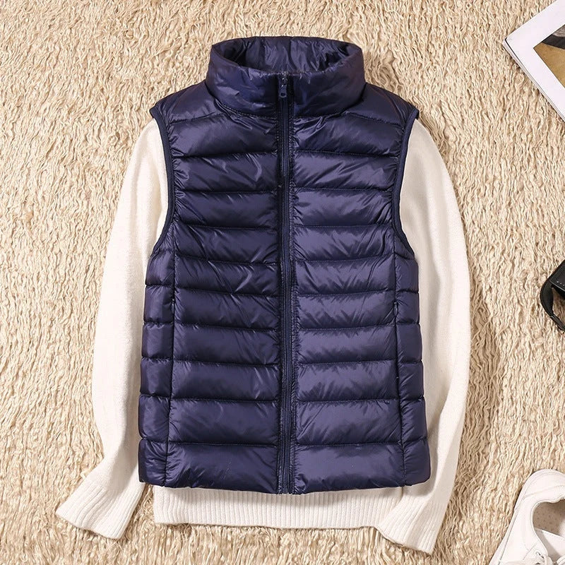 A dark blue padded women's gilet with a high collar and front zip.