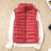 A red padded women's gilet with a high collar and front zip.