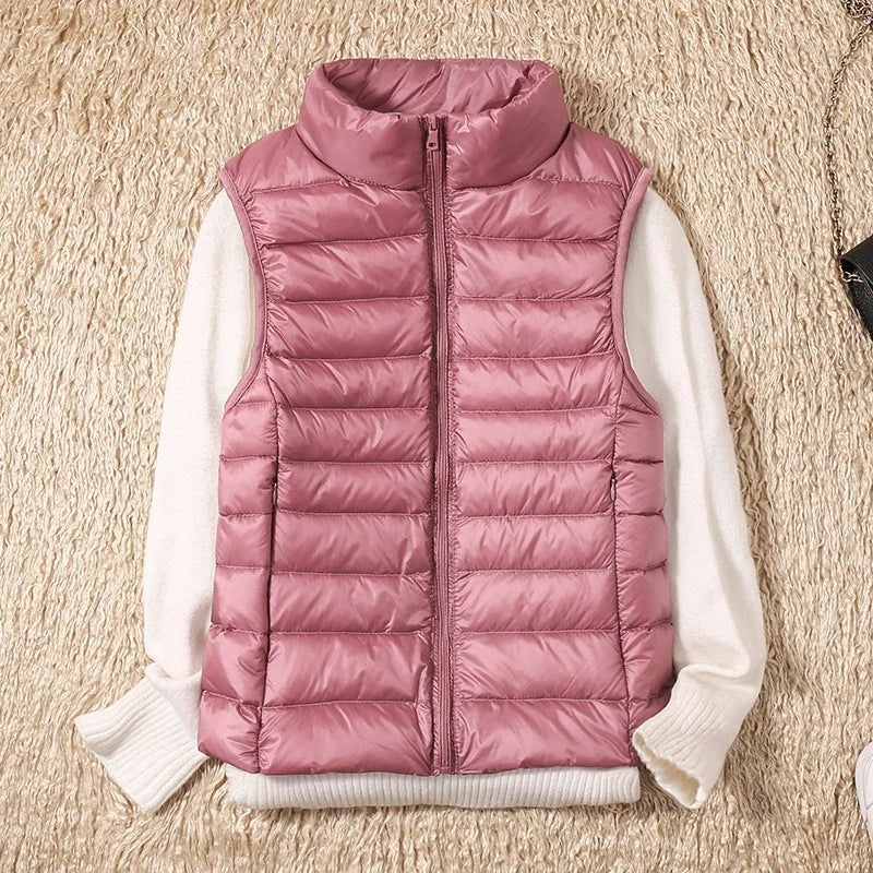 A rose-gold pink padded women's gilet with a high collar and front zip.
