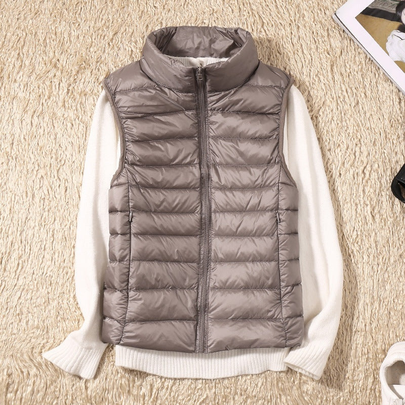 A grey-brown padded women's gilet with a high collar and zip