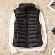 A black padded women's gilet with a high collar and zip