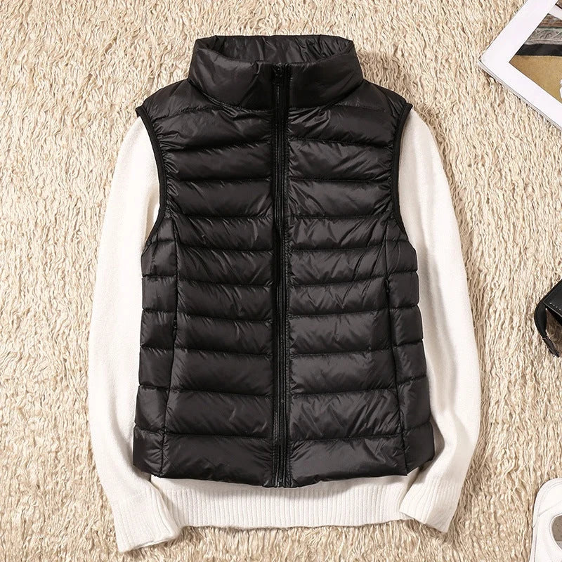 A black padded women's gilet with a high collar and zip