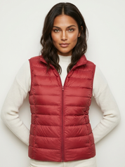 A red padded women's gilet with a high collar and zip