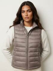 A taupe padded gilet with a high collar and zip