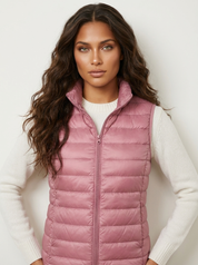 A pink padded gilet with a high collar and zip