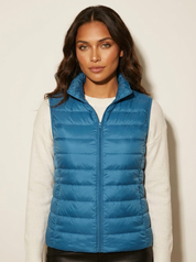 A bright-blue padded gilet with a high collar and zip