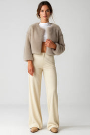 A straight-cut cropped beige women's furry jacket with an open front
