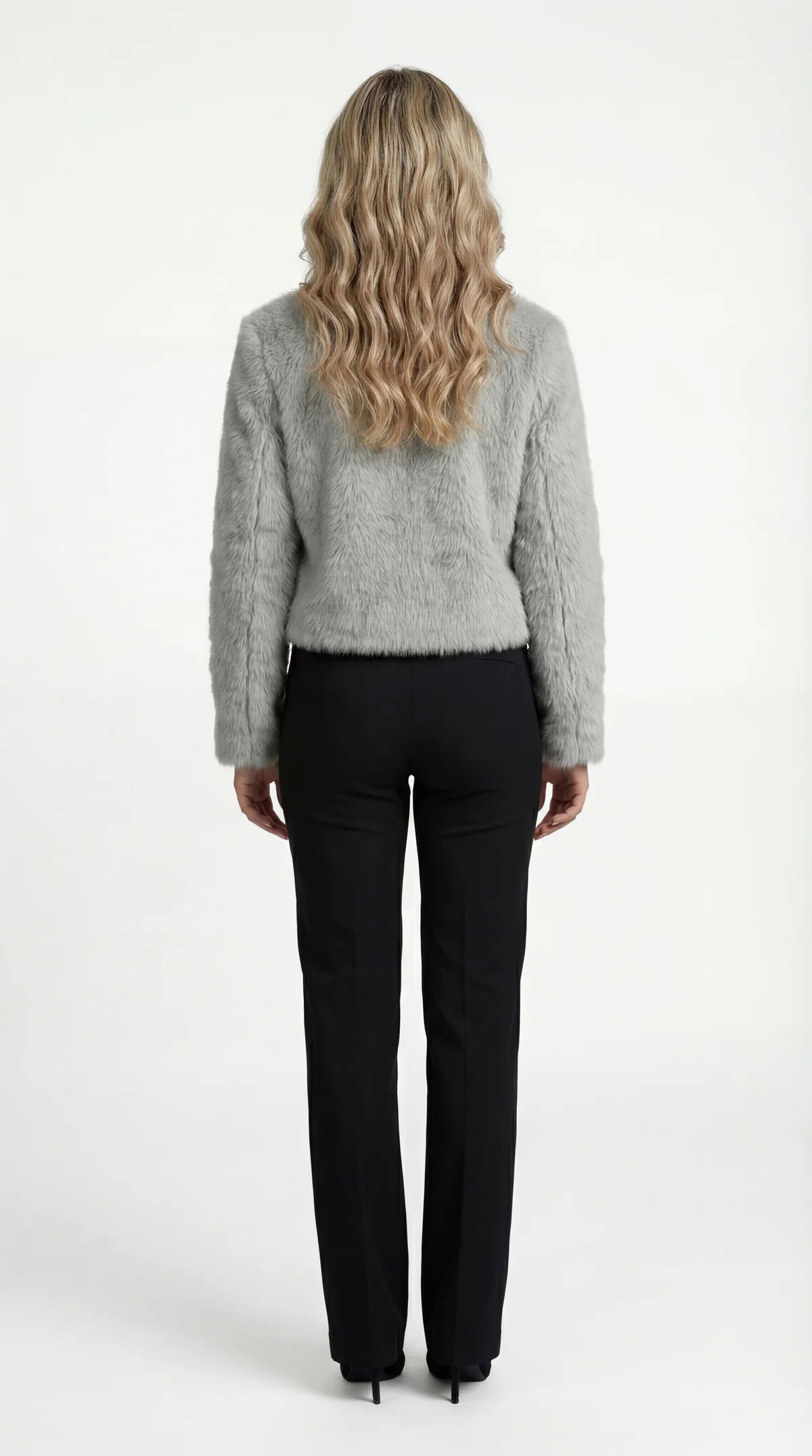 A cropped grey furry jacket with a round neck and sleeves, rear view