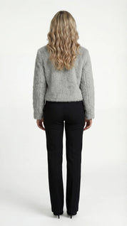 A cropped grey furry jacket with a round neck and sleeves, rear view