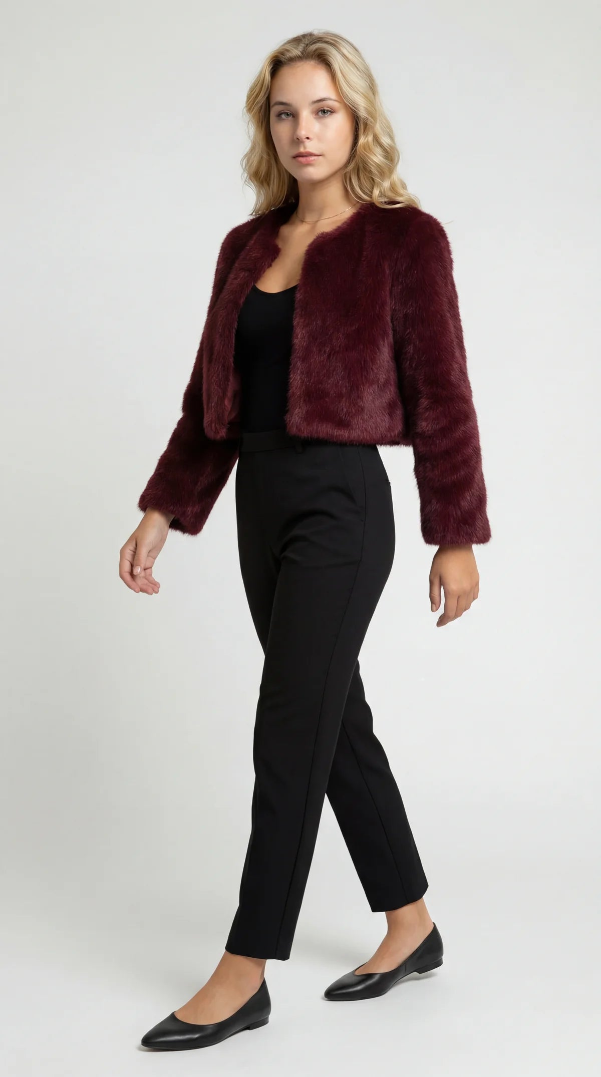 A cropped burgundy furry jacket with an open front and long sleeves