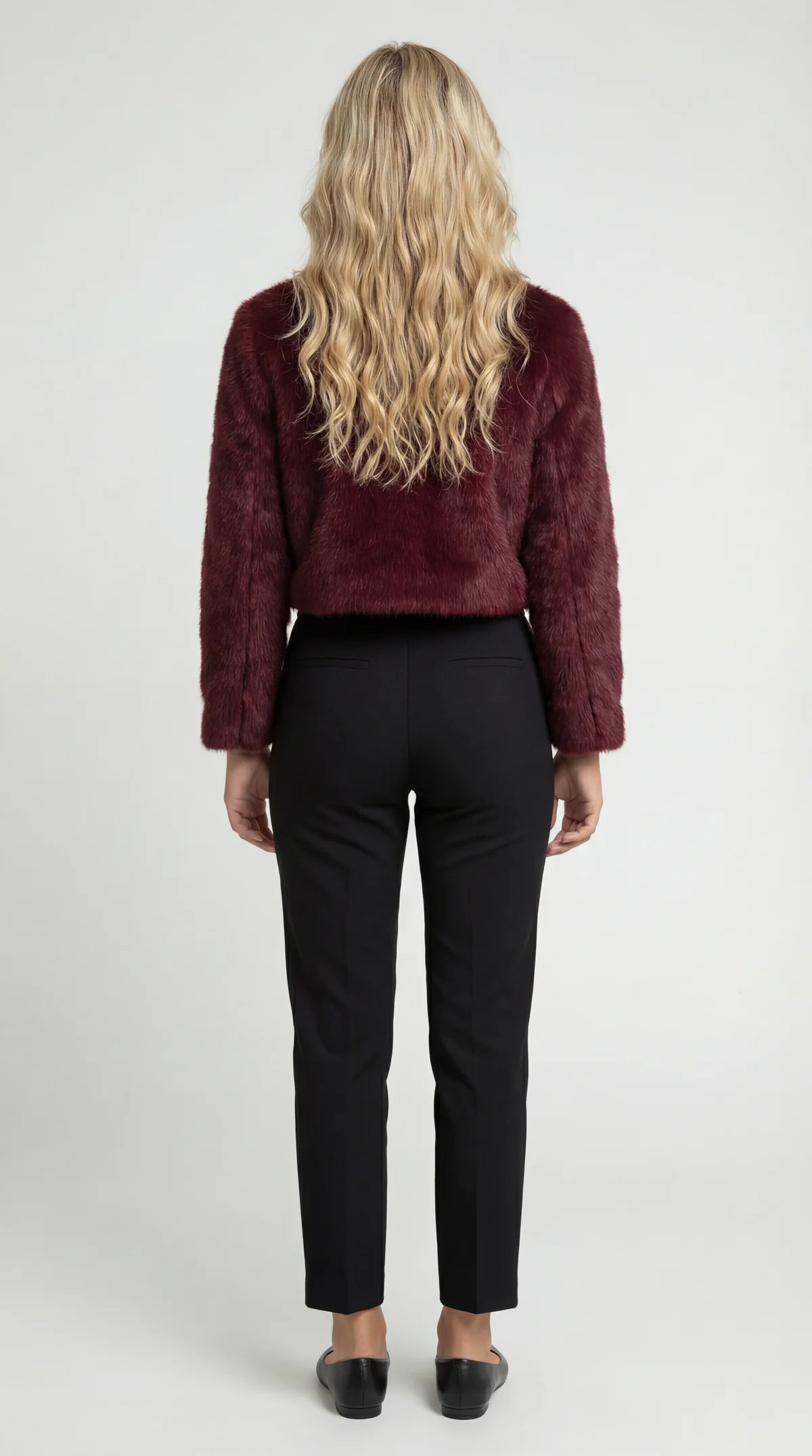 A cropped burgundy furry jacket with a round neck, rear view