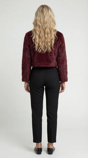 A cropped burgundy furry jacket with a round neck, rear view