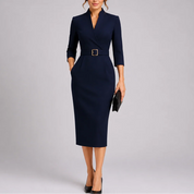 A navy blue V-neck midi dress with a buckled waist belt and three-quarter sleeves