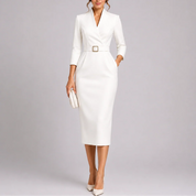 A white V-neck midi dress with a square-buckle belt and three-quarter sleeves