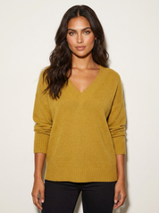 A loose-fitting yellow-brown knitted V-neck jumper with long sleeves.