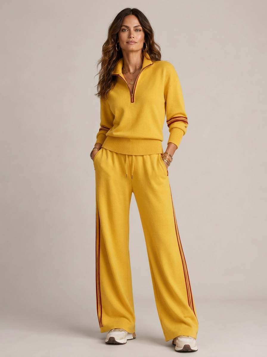 A yellow women's two-piece sports set with a zip-up jumper and wide-leg trousers with brown stripes