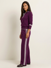 A purple women's two-piece sports set with a zip-up jumper and wide-leg trousers with white side stripes