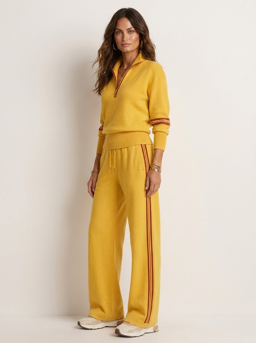 A yellow women's two-piece sports set with a zip-up jumper and wide-leg trousers with brown side piping