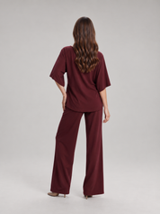Tweedelige set dames met gedrapeerde top en wijde broek