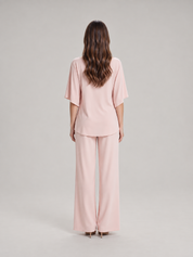 Tweedelige set dames met gedrapeerde top en wijde broek