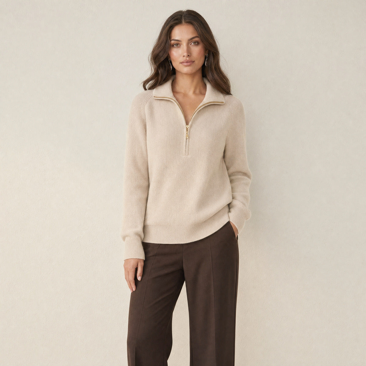 A model wearing a apricot women's knitted half-zip jumper with a collar, front view