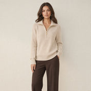 A model wearing a apricot women's knitted half-zip jumper with a collar, front view