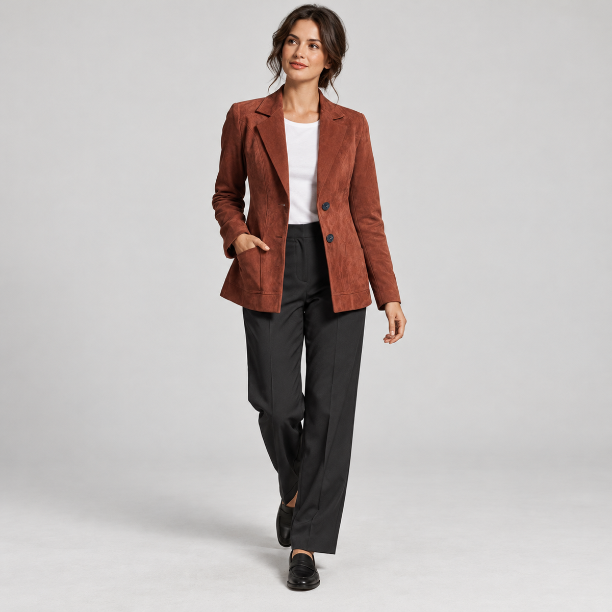 Women's brown fitted blazer with lining and pockets, worn by a female model in a walking pose