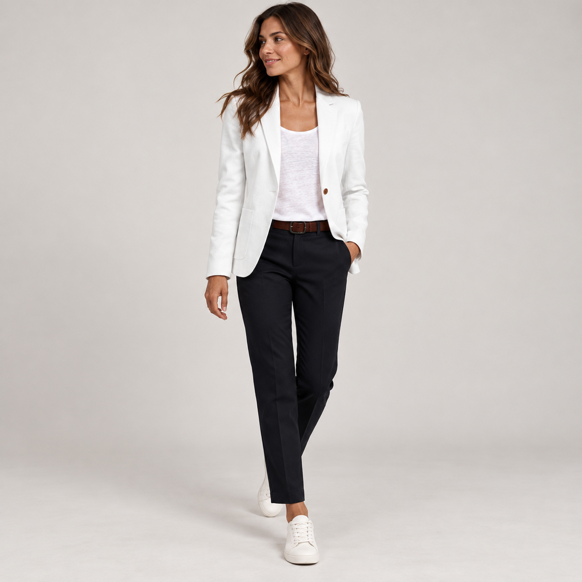 Women's fitted blazer with one button and a deep V-neck, worn by a female model, angled front view