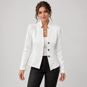Women’s blazer with cable-knit pattern and stand-up collar, worn by a female model, close-up